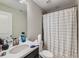 Bathroom featuring a modern vanity, toilet, and shower with a stylish curtain at 607 Azalea St, Brighton, CO 80601