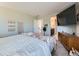 Comfortable bedroom with light gray walls, a large flat-screen television, and decor at 607 Azalea St, Brighton, CO 80601