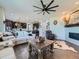 Spacious living room featuring a fireplace, ceiling fan, and an open floor plan at 607 Azalea St, Brighton, CO 80601