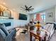 Comfortable living room featuring a cozy fireplace, large-screen TV, and hardwood floors at 607 Azalea St, Brighton, CO 80601