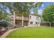 Backyard with a two-story deck and steps to the manicured yard at 11237 W Ford Dr, Lakewood, CO 80226