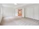 Spacious carpeted basement with walkout doors and plenty of storage at 11237 W Ford Dr, Lakewood, CO 80226
