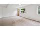 Finished basement area features carpet, windows and an exterior door at 11237 W Ford Dr, Lakewood, CO 80226