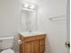 Bathroom with a wood vanity and a separate toilet area at 11237 W Ford Dr, Lakewood, CO 80226