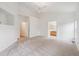 Large bedroom with plush carpeting and access to en suite bathroom at 11237 W Ford Dr, Lakewood, CO 80226