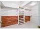 Spacious walk-in closet featuring custom shelving, wood paneling and ample storage space at 11237 W Ford Dr, Lakewood, CO 80226