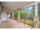 Covered deck with wood floors and railings offers a great view of the backyard at 11237 W Ford Dr, Lakewood, CO 80226