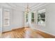 Dining room with hardwood floors, natural light, and elegant lighting fixture at 11237 W Ford Dr, Lakewood, CO 80226