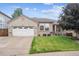 Charming brick home with a well-manicured lawn and attached two car garage at 11237 W Ford Dr, Lakewood, CO 80226