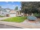 Beautiful brick home with mature landscaping and lush green lawn at 11237 W Ford Dr, Lakewood, CO 80226