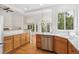 Bright, open kitchen with stainless steel appliances and hardwood floors at 11237 W Ford Dr, Lakewood, CO 80226