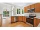 Light filled kitchen with stainless appliances, wood cabinets, and hardwood floors at 11237 W Ford Dr, Lakewood, CO 80226