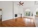 Bright living room with a fireplace, hardwood floors, and tall ceilings at 11237 W Ford Dr, Lakewood, CO 80226