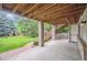 Covered patio area looking out to a manicured backyard with a putting green at 11237 W Ford Dr, Lakewood, CO 80226