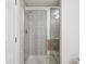 Modern bathroom shower featuring glass door, tiled walls and updated fixtures at 11237 W Ford Dr, Lakewood, CO 80226