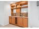 Basement wet bar with wood cabinets and wine storage at 11237 W Ford Dr, Lakewood, CO 80226