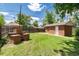 The backyard features a brick grill and a well-maintained lawn surrounded by a wooden fence at 2635 Julian St, Denver, CO 80211