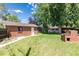 This backyard features a brick grill with a well-maintained lawn and access to the garage at 2635 Julian St, Denver, CO 80211