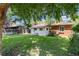 Backyard view features a well-maintained lawn and pathway leading to the back entrance at 2635 Julian St, Denver, CO 80211