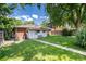 The backyard features a well-maintained lawn and pathway leading to the back entrance at 2635 Julian St, Denver, CO 80211