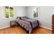 Well-lit bedroom featuring wood floors and bright windows at 2635 Julian St, Denver, CO 80211