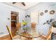 Cozy dining area featuring a glass table, wicker chairs, and plenty of natural light at 2635 Julian St, Denver, CO 80211