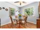 Bright dining area with a glass table and a view of the outdoor greenery at 2635 Julian St, Denver, CO 80211