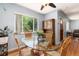 Charming dining area with a glass table, wicker chairs, and plenty of natural light at 2635 Julian St, Denver, CO 80211