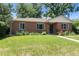 Brick home with manicured front lawn and garden beds, providing great curb appeal at 2635 Julian St, Denver, CO 80211