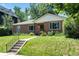 Traditional brick home with a well-kept lawn, front garden, and inviting walkway to the front door at 2635 Julian St, Denver, CO 80211