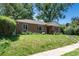 All brick home featuring a well-maintained lawn, lovely landscaping and an inviting front entrance at 2635 Julian St, Denver, CO 80211