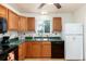 Functional kitchen with oak cabinetry, green countertops, and a clean white refrigerator at 2635 Julian St, Denver, CO 80211