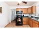 Practical kitchen with wood cabinets, black appliances, and ample countertop space at 2635 Julian St, Denver, CO 80211