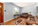 Warm and inviting living room with hardwood floors, an area rug, and large window at 2635 Julian St, Denver, CO 80211