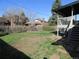 Large grass back yard with deck, trees and greenery, ready for outdoor enjoyment at 827 Hannibal Dr, Aurora, CO 80011