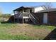View of back yard, deck, stairs and a glimpse of a partially covered patio area at 827 Hannibal Dr, Aurora, CO 80011