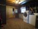 A laundry room in the basement with a washer and dryer, and a door to the outside at 827 Hannibal Dr, Aurora, CO 80011
