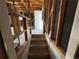 Basement stairway leading to unfinished space, framing is visible at 827 Hannibal Dr, Aurora, CO 80011