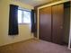 A bedroom with a window letting in natural light, and a large closet at 827 Hannibal Dr, Aurora, CO 80011