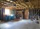Unfinished garage with visible framing, shelving and storage at 827 Hannibal Dr, Aurora, CO 80011