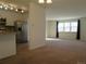 Open-concept living area connecting the kitchen and a bright sitting room at 827 Hannibal Dr, Aurora, CO 80011