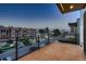Spacious outdoor balcony with sleek railings, wooden deck, and a neighborhood view at sunset at 3232 W 16 Ave, Denver, CO 80204