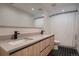 Modern bathroom with dual sinks and a shower featuring a patterned curtain and hexagon tile floors at 3232 W 16 Ave, Denver, CO 80204