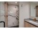Stylish bathroom with a walk-in shower featuring marble tile, providing a spa-like retreat within the home at 3232 W 16 Ave, Denver, CO 80204