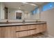 Elegant bathroom featuring dual sinks, wood cabinetry, and contemporary fixtures for a luxurious experience at 3232 W 16 Ave, Denver, CO 80204