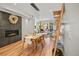 Dining area with fireplace, modern lighting, wood floors, and a convenient open floorplan to the living space at 3232 W 16 Ave, Denver, CO 80204