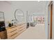 Bright hallway with modern dresser, mirror, and access to a private balcony with city views at 3232 W 16 Ave, Denver, CO 80204