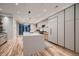 Modern kitchen with an island, sleek cabinets, stainless steel appliances, and a hardwood floor at 3232 W 16 Ave, Denver, CO 80204