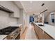 Modern kitchen with stainless steel appliances, custom cabinetry, and an open design at 3232 W 16 Ave, Denver, CO 80204