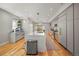 Bright kitchen features a large center island, stainless steel appliances, and light gray cabinetry at 3232 W 16 Ave, Denver, CO 80204